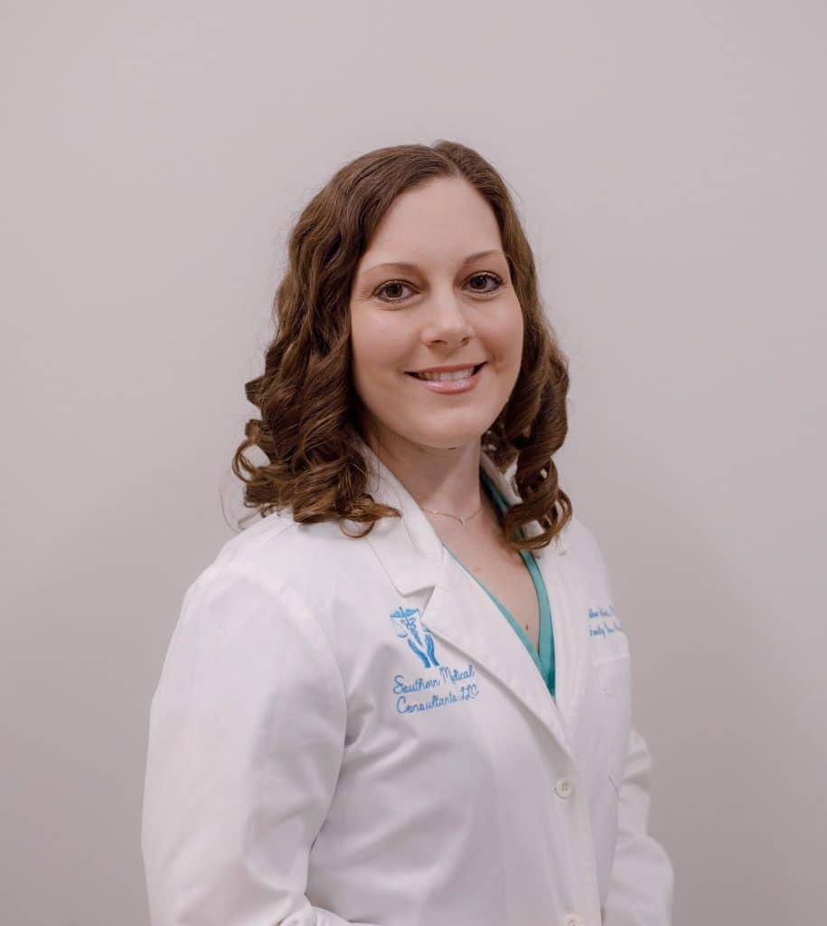 Smiling woman in a white coat